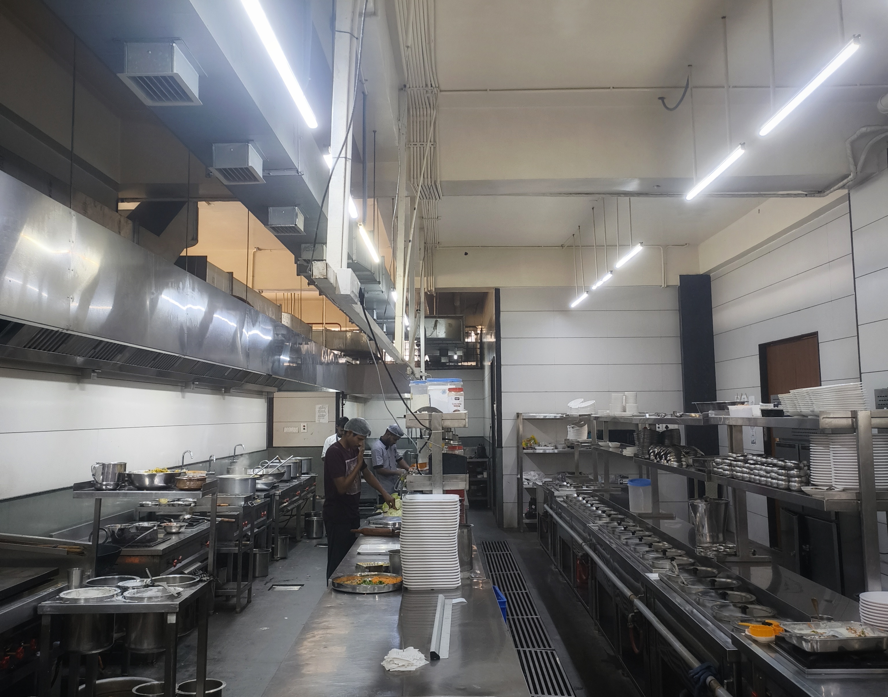 Professional kitchen at Spoorthi Delicacy with chefs preparing fresh dishes